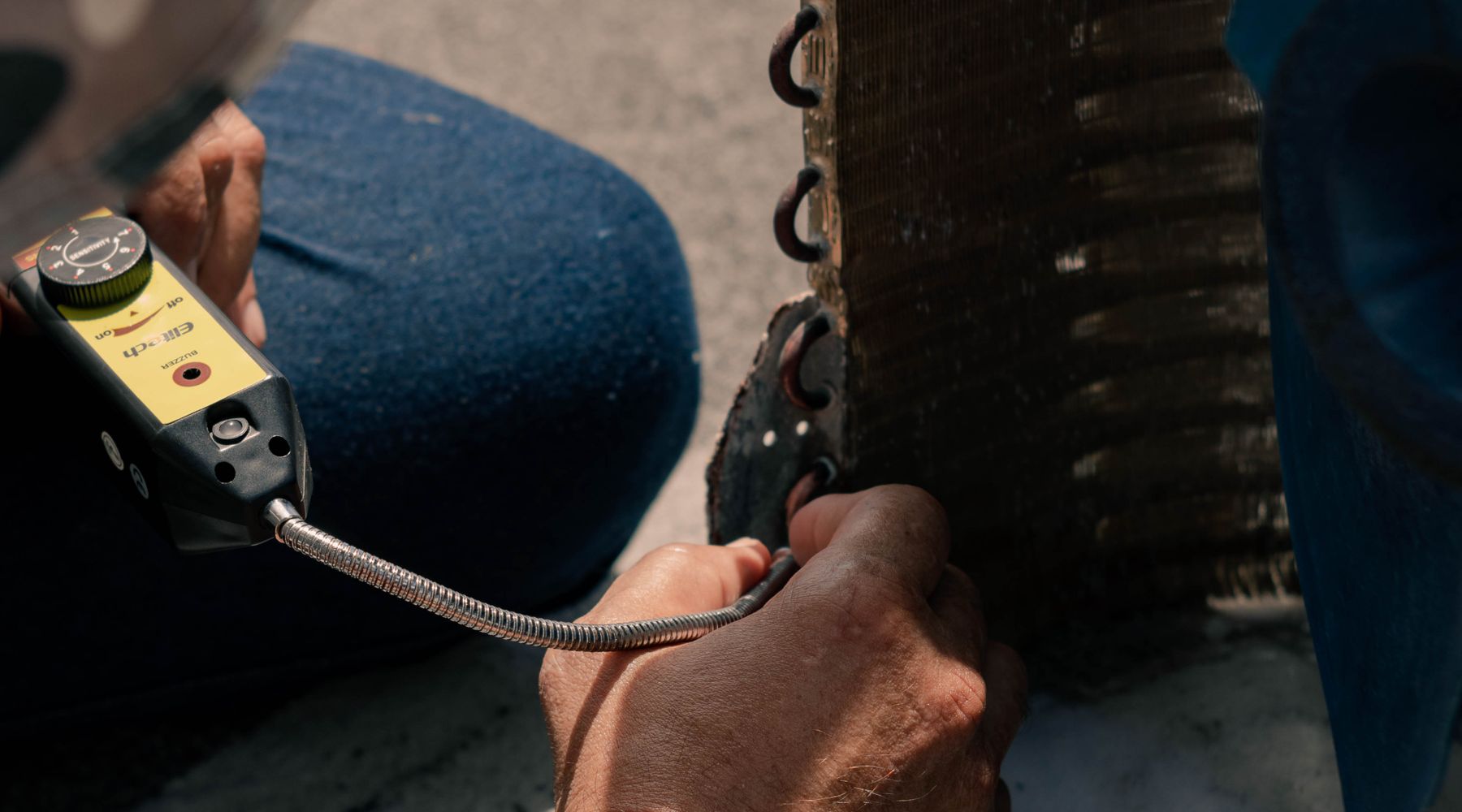 Technician servicing air conditioning equipment